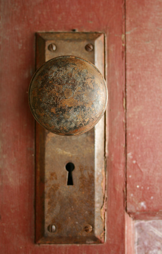 Closeup of old rusty doorknob with keyhole.