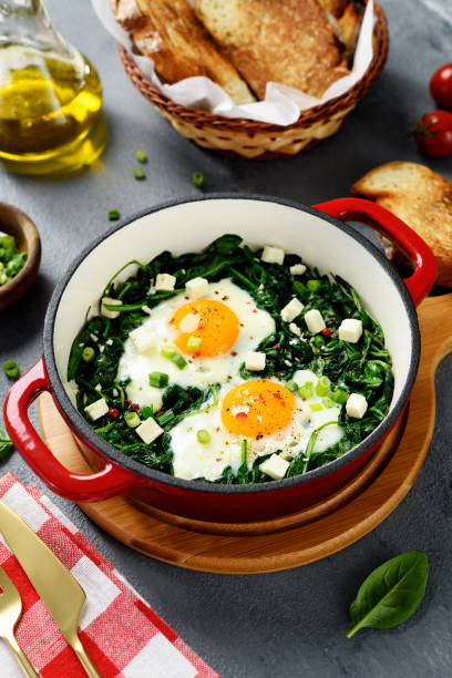 istock Green shakshuka with fresh spinach, fried eggs and feta cheese 1826597401
