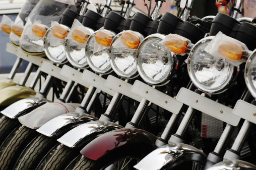 Row of motorbikes on display at an auto store.