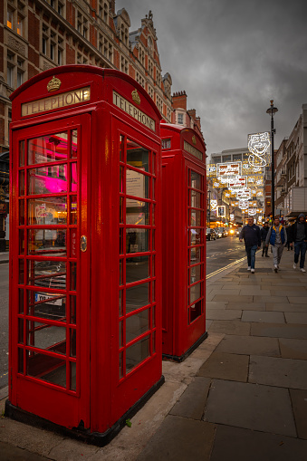 London, UK - Nov 20 2023: Red public telephone boxes in St Martin's Lane in central London.