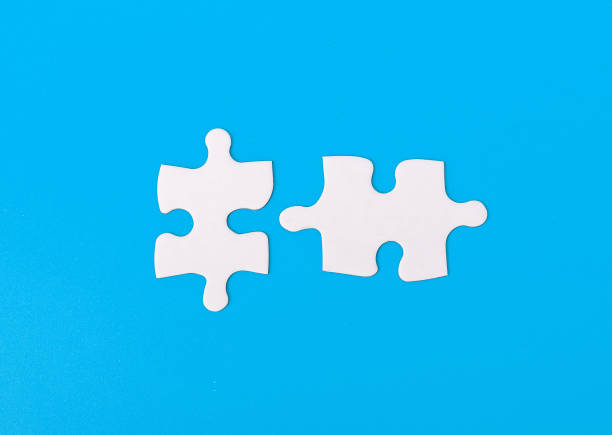 istock Matching, connecting two puzzle pieces together 1826599970