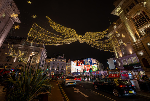 London, UK - Nov 20 2023: Piccadilly Circus seen from Regent Street St James's in central London. Christmas lights are overhead.