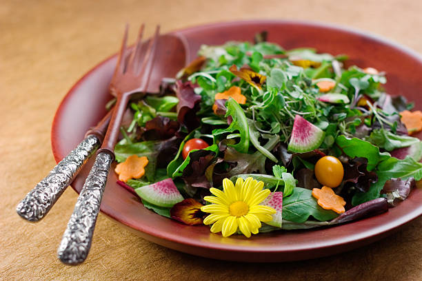 istock Spring salad with fancy spoon and fork on a brown plate 182660297