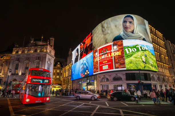 London, UK - Nov 20 2023: Piccadilly Circus and its famous lights in Central London. With red London bus and people.