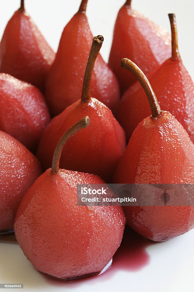 Poached pears tight group. "A group of pears poached in red wine and spices, with a syrup sauce.Too see more of my food related images, click on the banner." Close-up Stock Photo