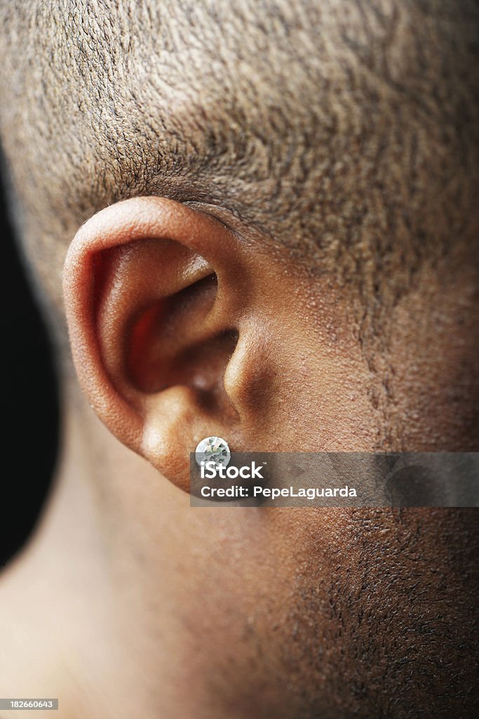 Listen carefully... A young man's earing. Ear Stock Photo