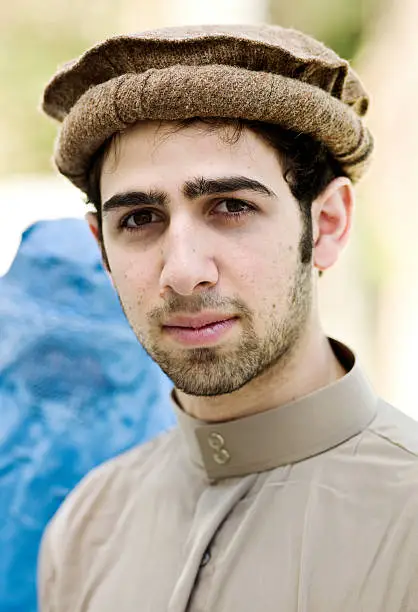 Headshot of an Afghan young man looking at the camera  (this picture has been taken with a Hasselblad H3D II 31 megapixels camera) 