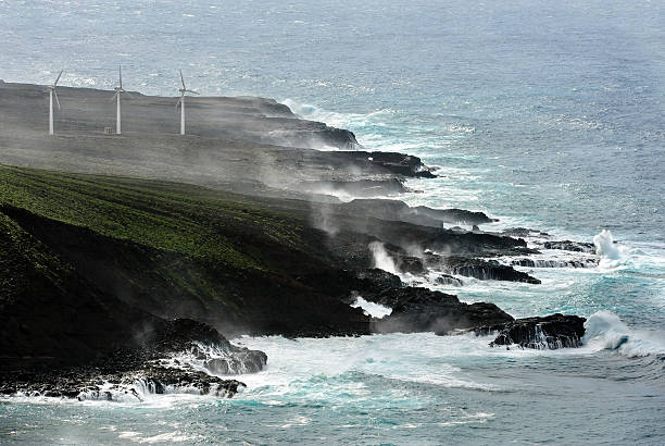 aerial view of wind turbines at a d rocky coastline stock photo