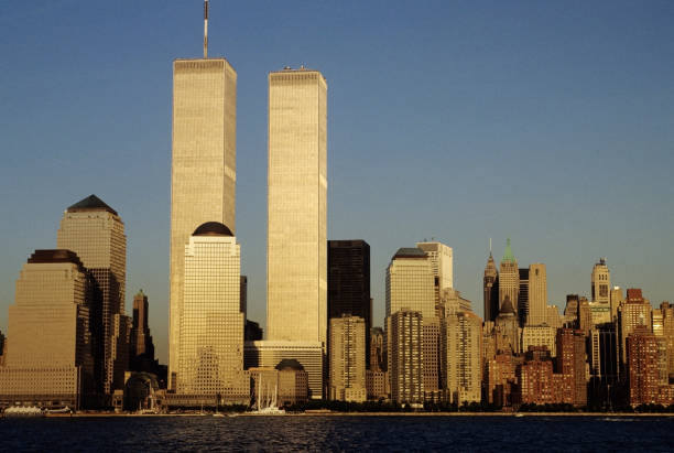 NYC skyline with the twin towers, from across the river The NYC skyline with the World Trade Center seen from NJ twin towers manhattan stock pictures, royalty-free photos & images