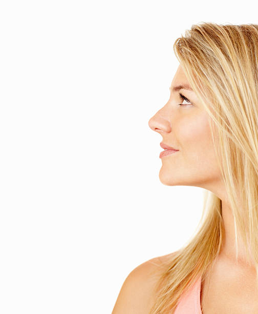 istock Smiling young lady looking up at copy space 182661412