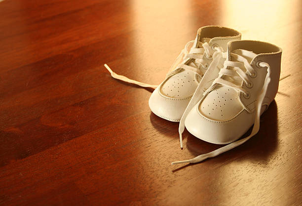 istock Baby Shoes in Light on Wood 182661621