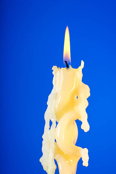 Graceful candle Beautiful burning candle on a blue background melting wax stock pictures, royalty-free photos & images