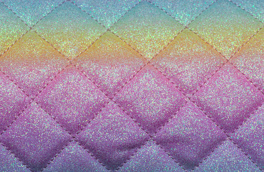 Rhombus pattern stitch. Quilted colorful fabric as background.