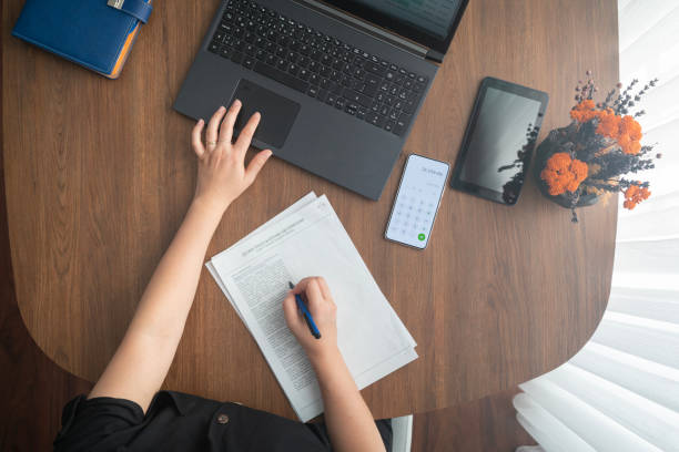 istock Adult woman working at home (laptop, document, telephone).E-learning concept. Online classes 1826618498