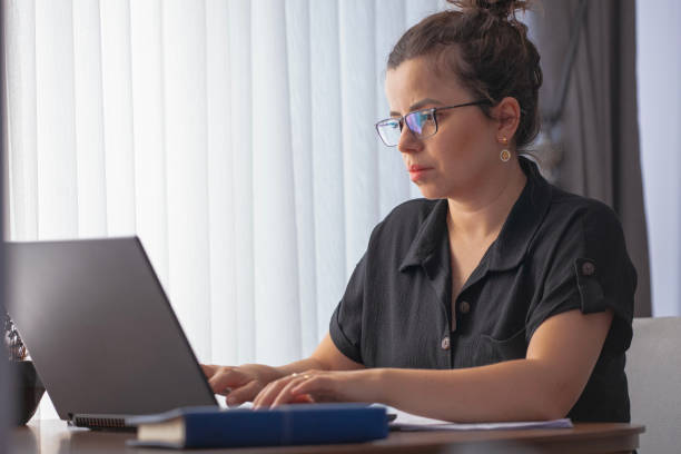 istock Adult woman working at home (laptop, document, telephone).E-learning concept. Online classes 1826619557
