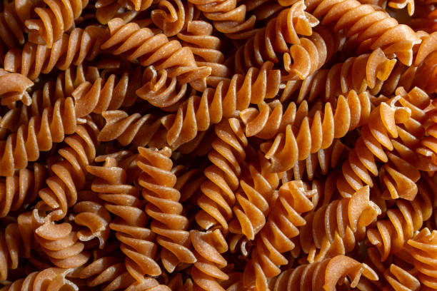 istock Uncooked Whole Grain Fusilli Pasta Background 1826626743