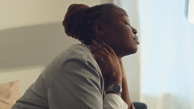 Tired Black Female Doctor Massaging Neck after Long Shift
