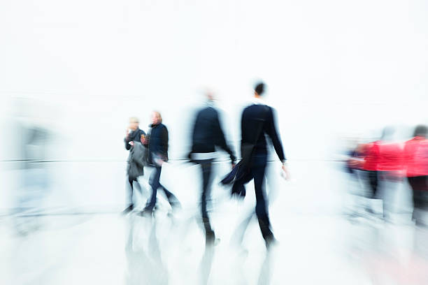 Commuters Walking in Corridor, Blurred Motion "group of people walking in futuristic interior, motion blur and zoomClick here to view more related images:" wall sidewalk city walking stock pictures, royalty-free photos & images