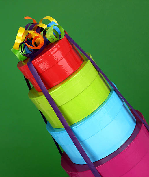 Gift Boxes on Green "Colorful, cylindrical gift boxes tied with curling ribbon on green backgroundPlease click on the image below to view my Gift Images Lightbox:" stacked hat boxes stock pictures, royalty-free photos & images