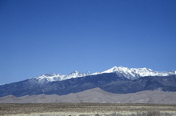 istock Sand Dunes and a Snowy Mountain 182663248