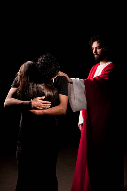 istock Embraced couple with Jesus by their side 182664258