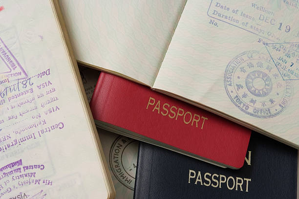 Close-up of stacked passports and stamp page Stacked passports and Stamp Page.Studio shot. embassy photos stock pictures, royalty-free photos & images