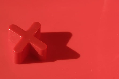 plastic alphabet ' X ' in red background