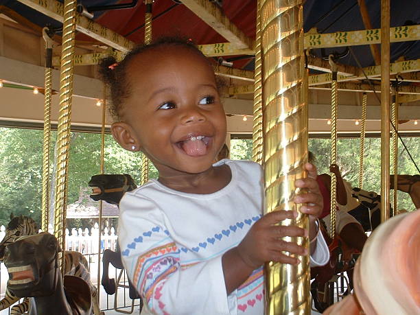 muy merry-go-round - carousel merry go round child african descent fotografías e imágenes de stock