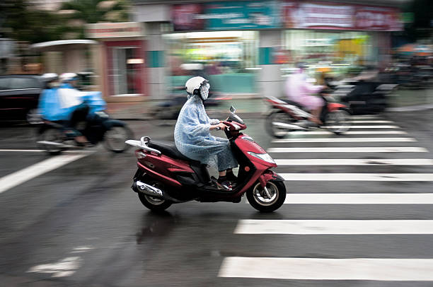 riding a motorcycle in the rain - runabout стоковые фото и изображения