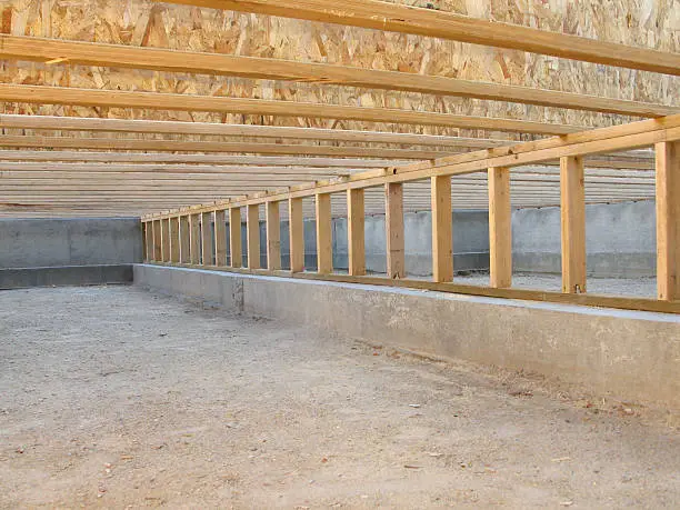 Photo of Construction Site: Neat Clean Crawlspace, Floor Joists, and Pony Wall