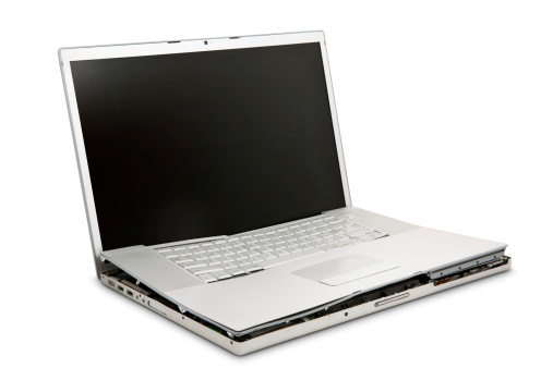 A destroyed laptop isolated on a white background.