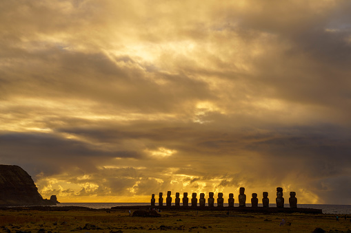 Rapa Nui ancient civilization - Moai statues in Idyllic countryside and pacific ocean waves at coastline shore, dramatic landscape panorama – Chile