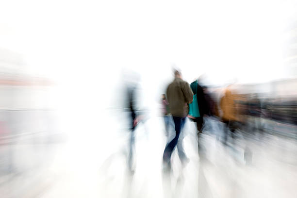 Motion blur shot of people rushing in corridor "people walking in a modern interior, zoom blur, motion blurClick here to view more related images:" wall sidewalk city walking stock pictures, royalty-free photos & images