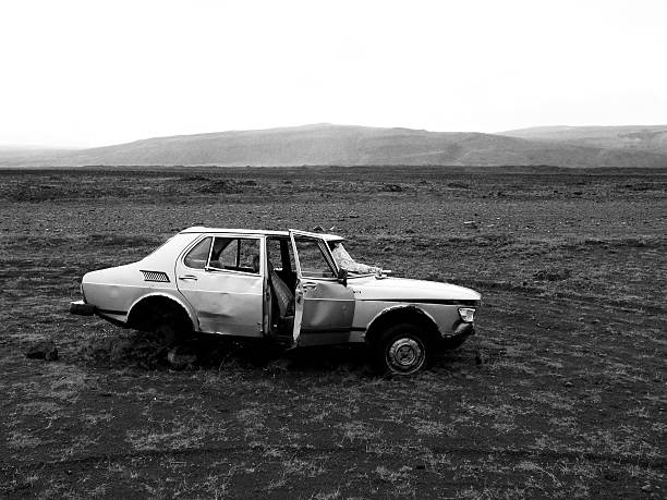 A broken car stands in a lonely desert in the highlands of Iceland.