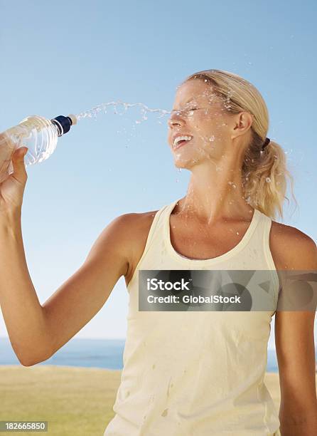Happy Female Throwing Water On Her Face To Cool Off Stock Photo - Download Image Now