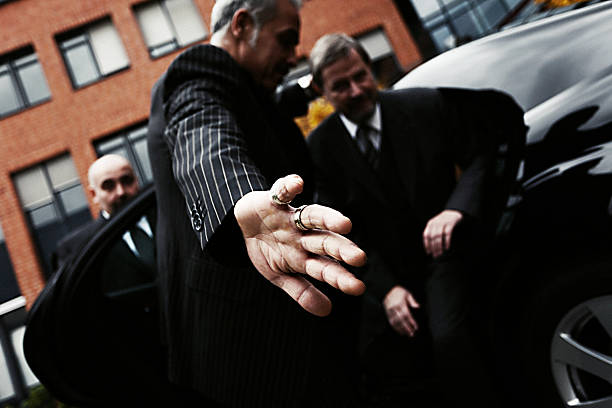 Bodyguards at Work Bodyguards protecting man coming out of car. Noise added. celebrity limo stock pictures, royalty-free photos & images