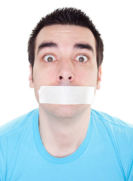 istock Man with adhesive tape over mouth. 182666924