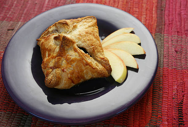 Apple dumpling presented on a purple plate  stock photo