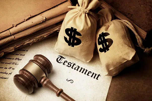 gavel testament document and canvas bags with dollar sign representing inheritance concept