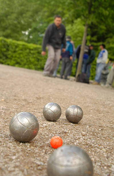 A set of boules with players in the background