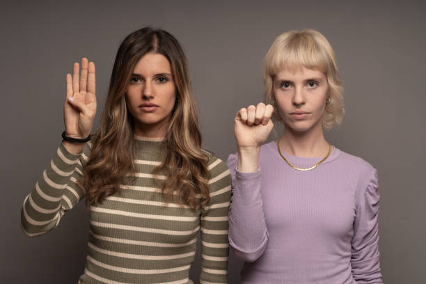Women's SOS Hand Signal Against Violenc Two women raising hands in a silent plea, showcasing the SOS sign against domestic violence, promoting awareness and support. woman stealth stock pictures, royalty-free photos & images