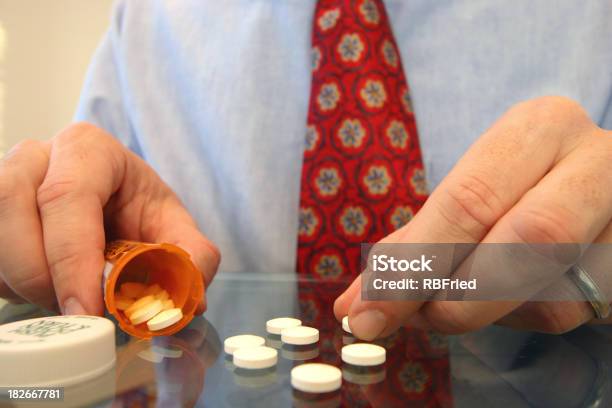 Man Sorting His Depression Medication On Glass Table Stock Photo - Download Image Now