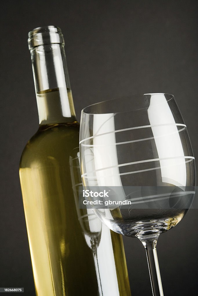 White wine A bottle of white wine and an empty glass. Aging Process Stock Photo