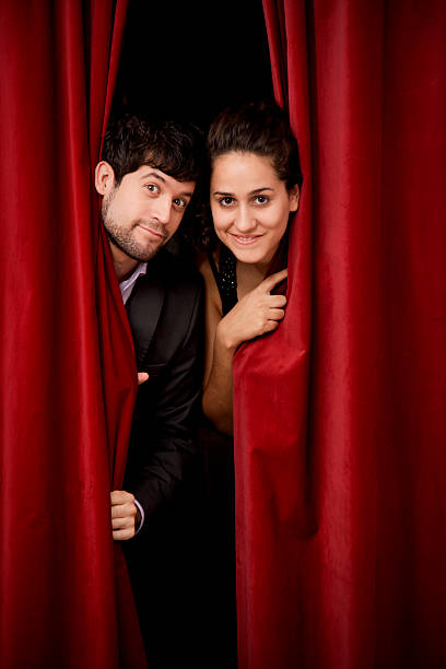 istock Actress and actor peeking to the public. 182668538