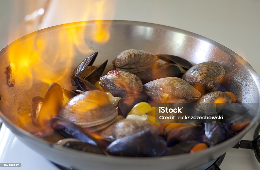 sauteed clams on fire Clam - Seafood Stock Photo