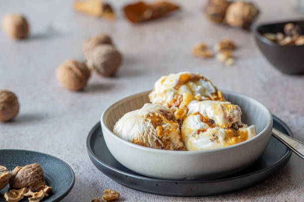 istock walnut ice cream in a dessert bowl, nuts around 1826687896