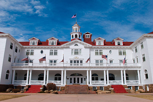 Stanley Hotel with blue sky in Estes Park, Colorado "Wide-angle view of the Stanley Hotel in Estes Park, Colorado with a rich blue sky in the background." estes park stock pictures, royalty-free photos & images