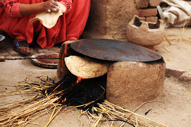 istock Indian Rural Lifestyle Making Chapati Mud Stove 182669428