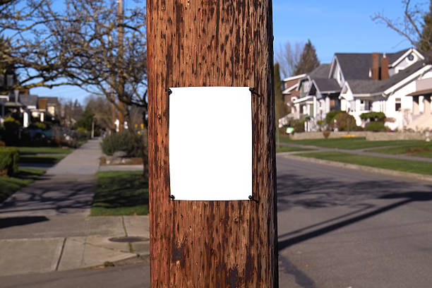 Neighborhood Post "Photo of a blank sheet of white paper fastened to a wooden electrical pole, quaint suburban neighborhood visible in the background." pole photos stock pictures, royalty-free photos & images