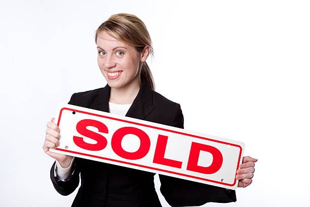 A sold sign in the shape of a \